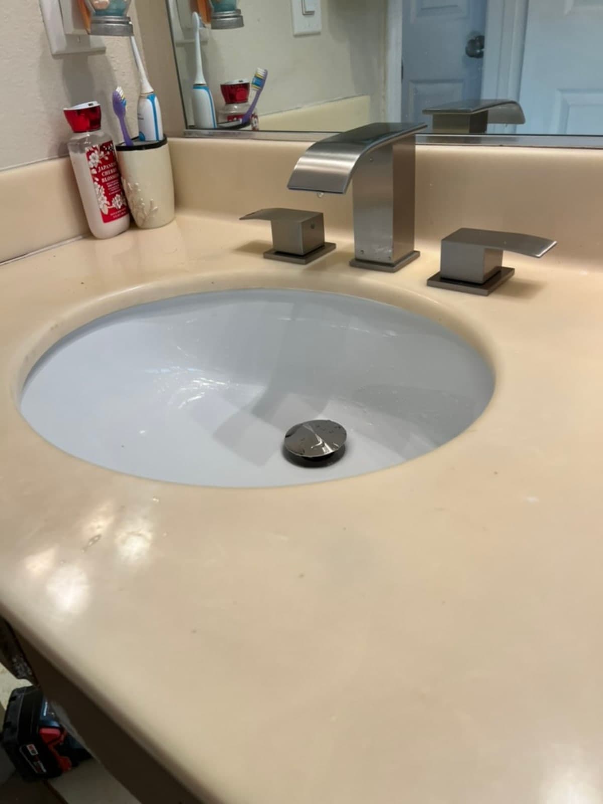 Modern brushed nickel widespread bathroom faucet installed on vanity