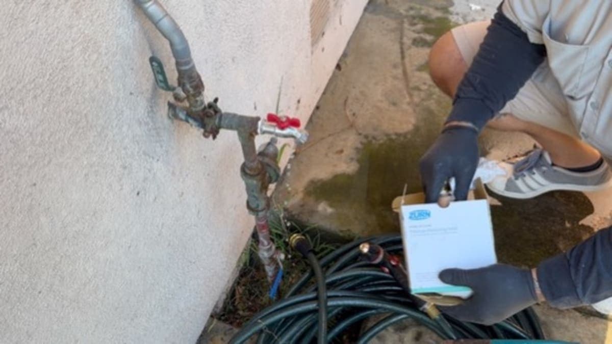 Jack's Plumbing technician with Zurn pressure regulator at job site