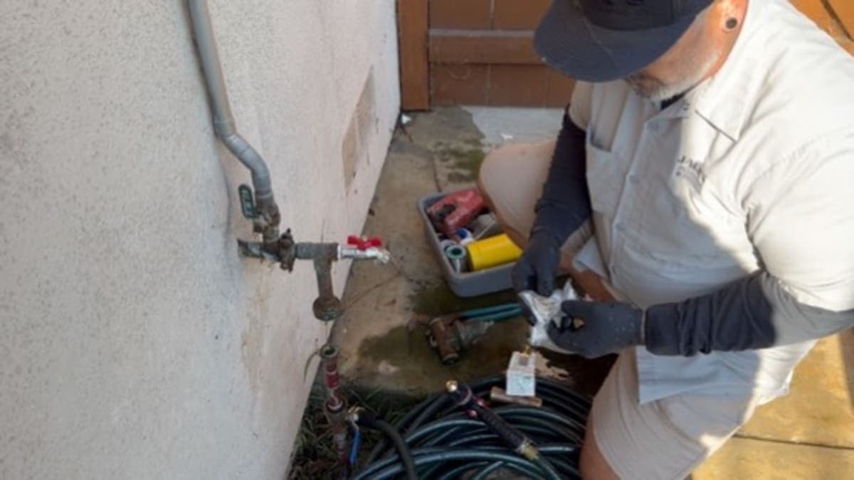 Jack's Plumbing technician performing radiant heating work at a Carlsbad home