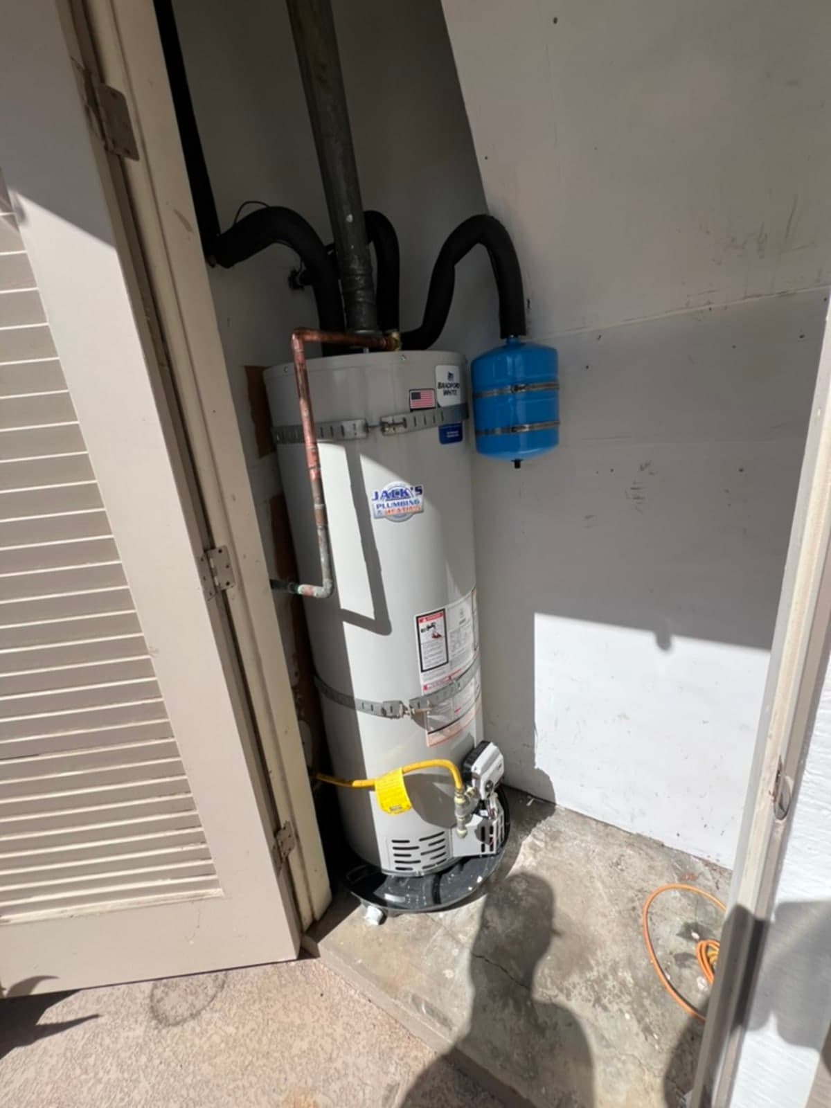 Bradford White water heater with blue expansion tank and earthquake straps