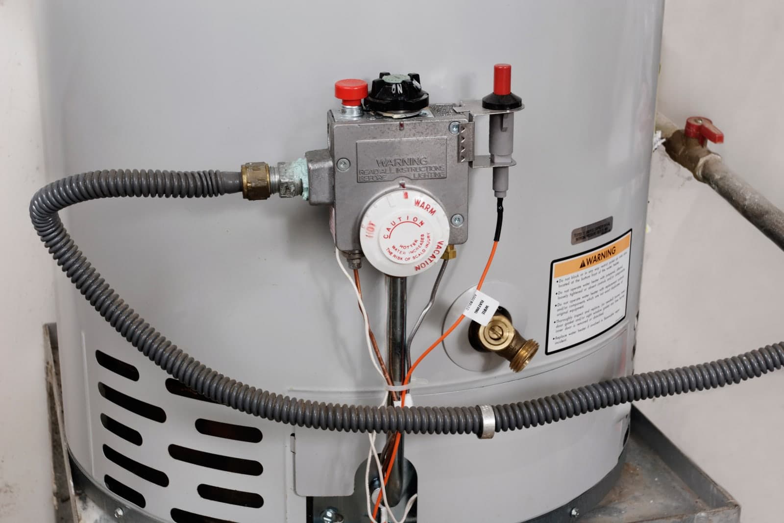 Close-up of the bottom of a water heater tank where hard-water sediment collects and corrosion begins