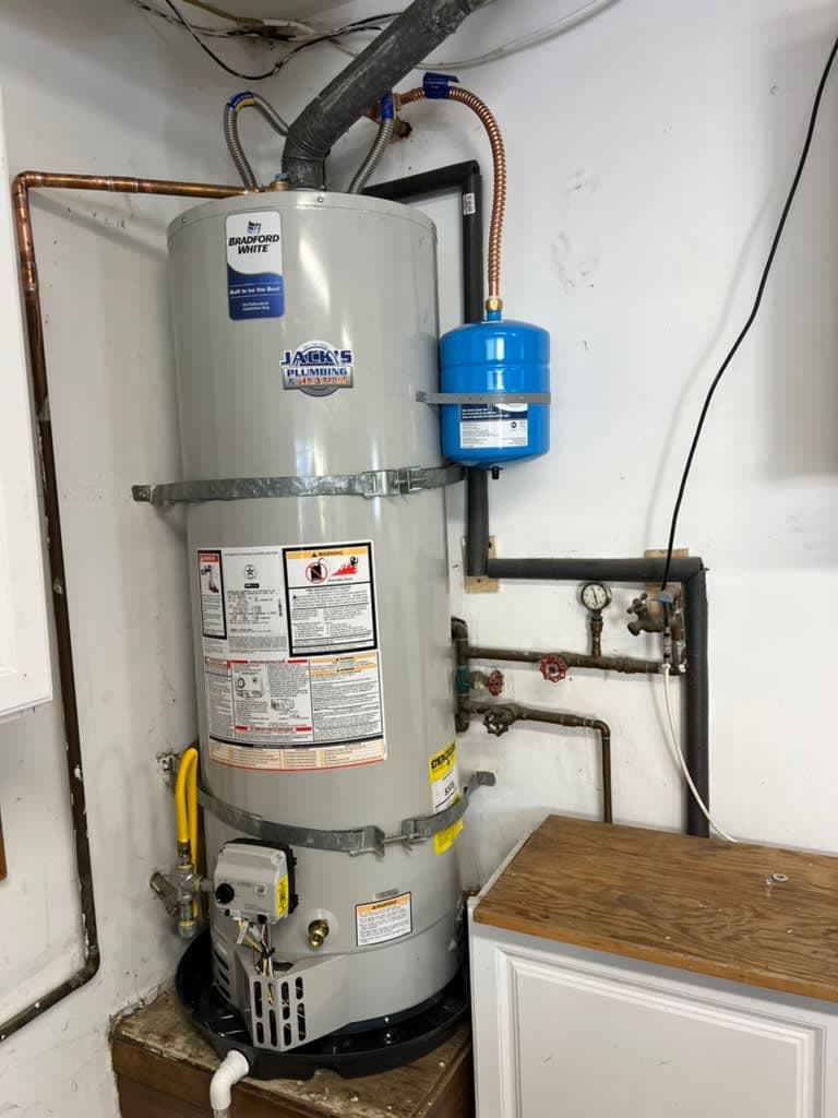 A new Bradford White gas storage-tank water heater cleanly installed in a Carlsbad garage